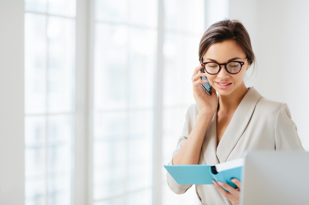 business lady discusses working schedule with partner via modern smartphone