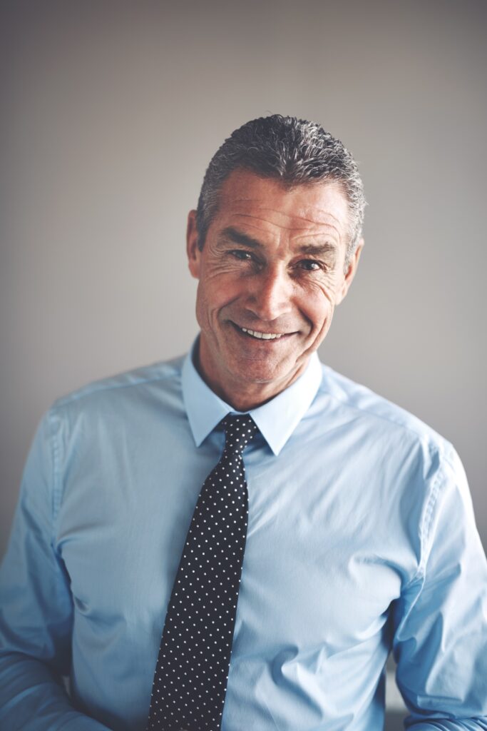Smiling mature corporate executive wearing a shirt and tie